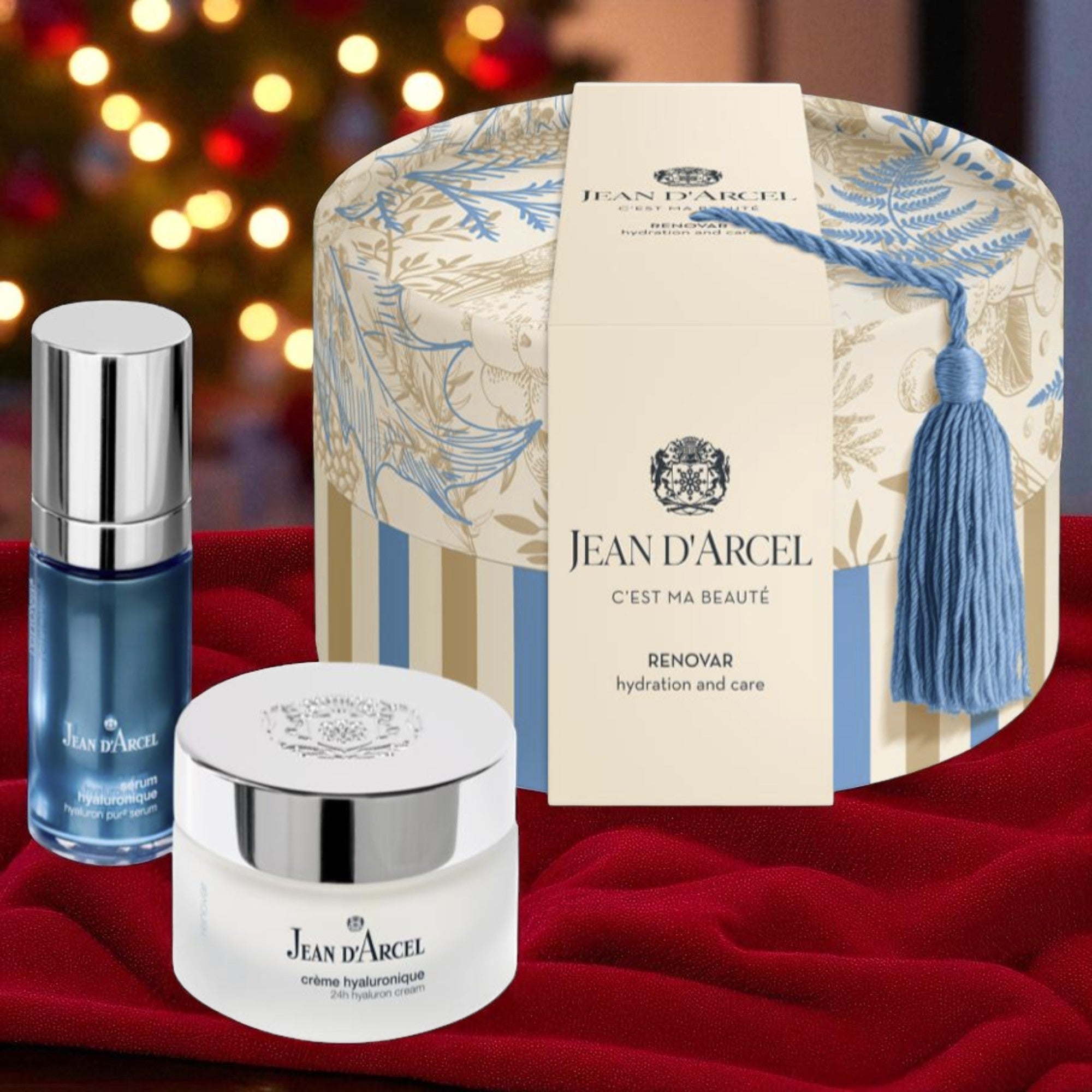 JEAN D'ARCEL Geschenkset RENOVAR – 50ml+30ml, RENOVAR Creme + Serum + Geschenkkarton vor weihnachtlichem Hintergrund
