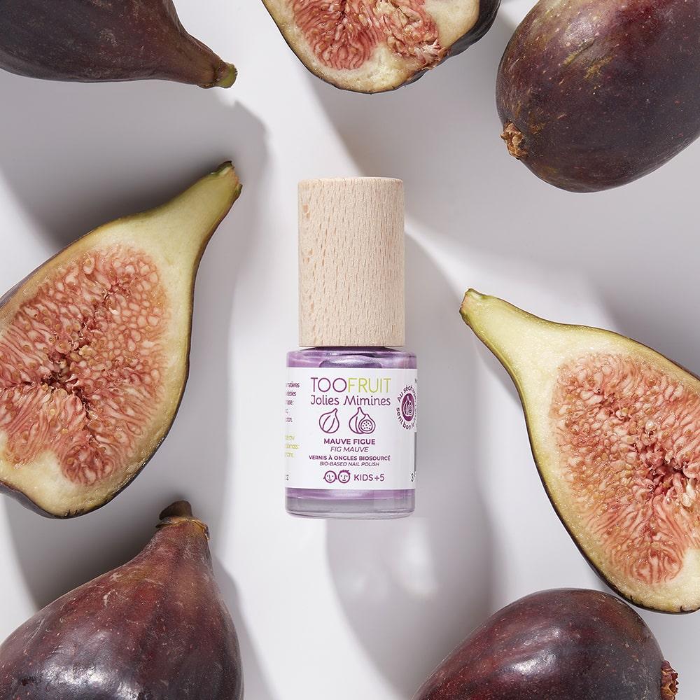 TOOFRUIT Nagellack Feige – 10ml, Pinselflasche umringt von halbierten Feigen