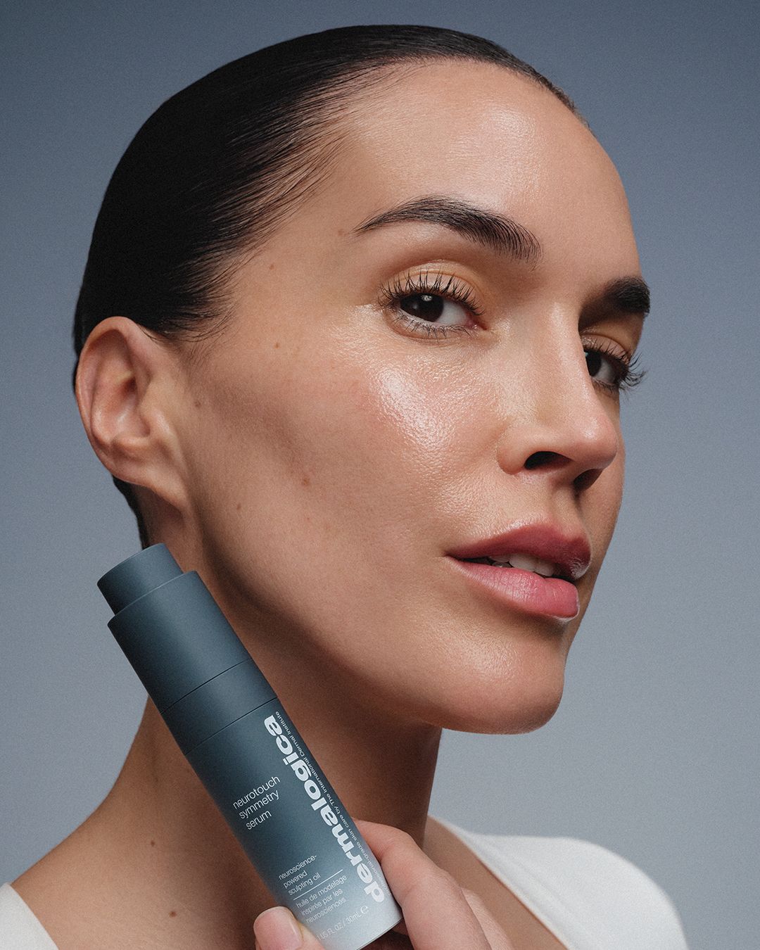 DERMACOLOR NeuroTouch Symmetry Serum  – 30ml, Frau hält Serum