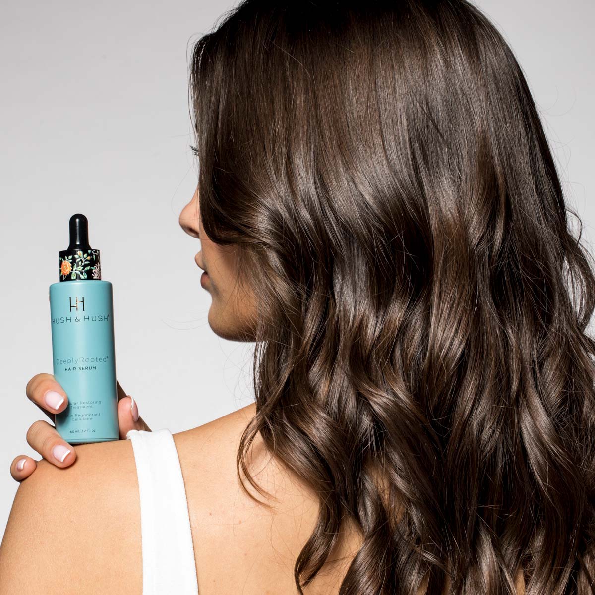 HUSH & HUSH DeeplyRooted Hair Serum – Leave-in-Haarserum, 60ml, Frau hält Serum an Schulter