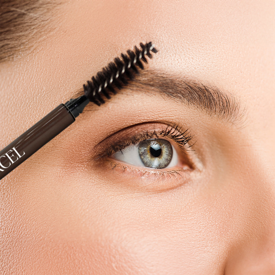 JEAN D'ARCEL eye brow pencil – dark, 1stk, cropped view of woman holding eyebrow brush near eyebrow