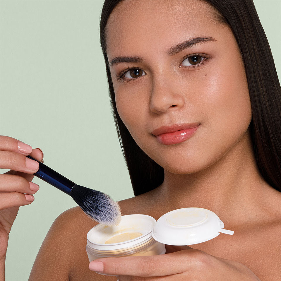 KRYOLAN Natural Finish Powder  – Fixierpuder für Make-up, 15g, Model hält Dose und Puderpinsel